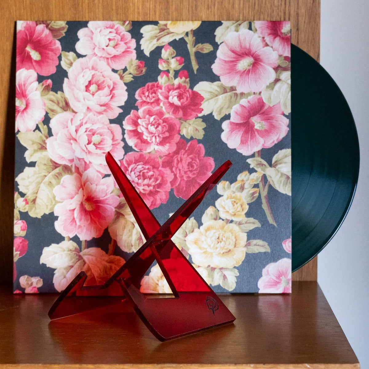 Red vinyl record stand displaying an LP record, Dubird Melbourne